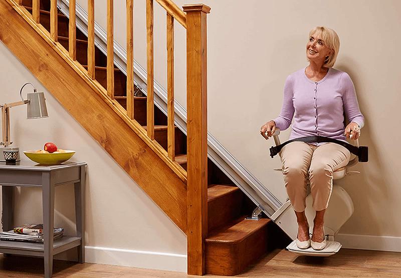 Person sitting on an Acorn 130 stairlift with seatbelt fastened